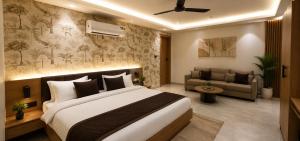 a bedroom with a large bed and a couch at Velara Hotel & Banquet in Gwalior