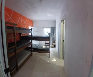 a room with bunk beds in a room with a hallway at Espaço Recanto dos Sonhos DR in Itaquaquecetuba