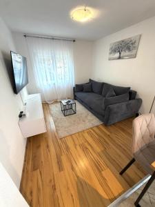 a living room with a couch and a table at Villa Orange Peaceful Holiday Retreat in Zadar