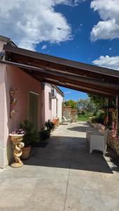 a covered patio with a bench and a building at La Margherita in Ortona