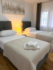 a hotel room with two beds with towels on them at Villa Orange Peaceful Holiday Retreat in Zadar +43 photos