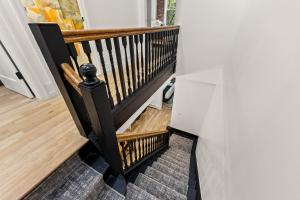 a stairway with a black and wooden railing at The West 142nd Street Apartments - Manhattan NYC in New York