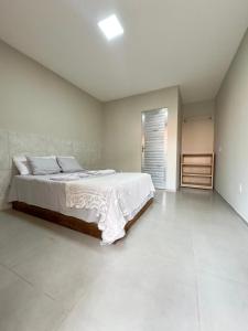 a bedroom with a large bed in a room at Lazer Hostel in Barreirinhas