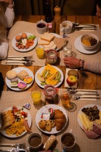 a table with plates of food on it at Ljubljana Resort Hotel & Camping in Ljubljana
