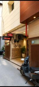 a scooter parked in front of a building at Hotel Atithi Palace in Sahāranpur +6 photos