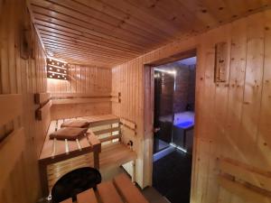 a wooden cabin with a sauna with a tub at Gościniec Pięciu Stawów in Ustrzyki Dolne