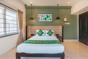 a bedroom with a large bed and a window at Treebo Premium Vapr Ashok Nagar in Chennai