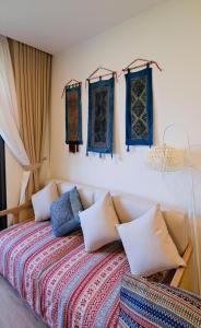 a bedroom with a bed with pillows and windows at Lia Home in Sapa +32 photos