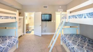 a bedroom with bunk beds and a tv at 123 Mariners Club in Key Largo +45 photos