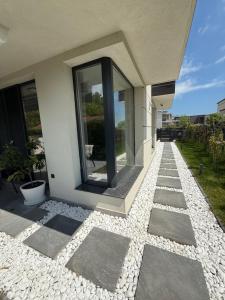 a house with a stone walkway in front of it at Вила Солана - Villa Solana in Lozenets