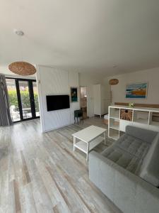 a living room with a couch and a table at Вила Солана - Villa Solana in Lozenets