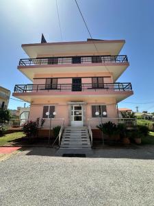 a building with a staircase leading up to it at Hotel TSAPARAS in Alíartos