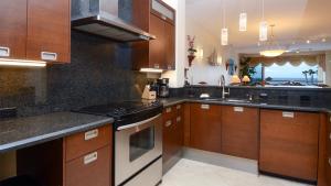 a kitchen with wooden cabinets and a stove top oven at 124 Mariners Club in Key Largo