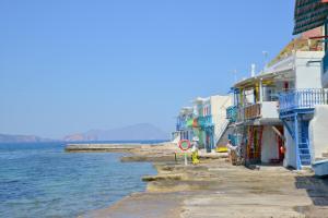 a group of buildings next to the water at Seafis Boathouse Klima in Klima