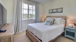 a bedroom with a bed and a window at 311 Mariners Club in Key Largo +42 photos