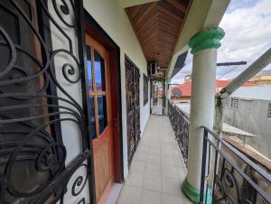 an entrance to a building with a gate and a balcony at Baobab Lodge Douala - Makepe in Douala