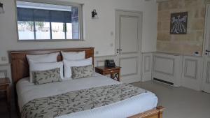 a bedroom with a large bed and a window at Château la Rose Perriere in Lussac
