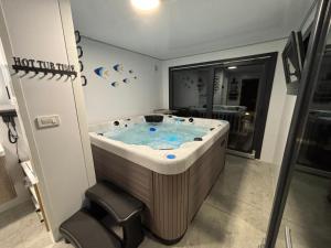a jacuzzi tub in a room with a window at Guest House Sidro - Wellness & Restaurant in Selce