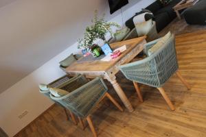 a wooden table with two chairs and a table at Sternennächte auf einem echtem Bauernhof in Warpke