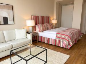 a hotel room with a bed and a couch at Strandhotel Miramar in Timmendorfer Strand