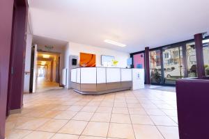 a large hallway with a tile floor and white walls at med Apart in Erlangen