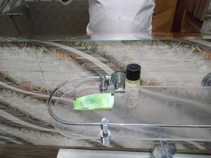 a bathroom sink with a bottle of water on it at Snow Range Cottages in Manāli +37 photos