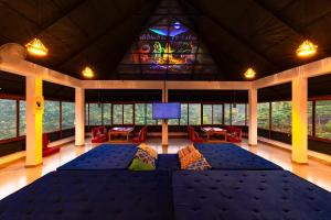 a large room with a couch and a stained glass window at Monkey Tribe Vagamon in Vagamon