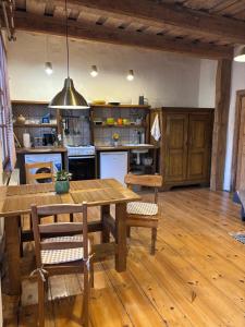 a large kitchen with a wooden table and chairs at Central & Quiet Cēsis Stay in Cēsis