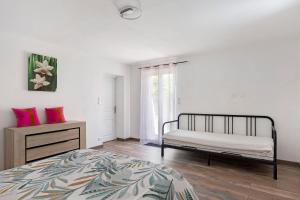 a bedroom with a bed and a dresser and a window at Le Gîte Des Anges - 4pers, Piscine in Angé +18 photos
