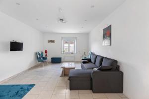 a living room with a couch and a table at Le Gîte Des Anges - 4pers, Piscine in Angé