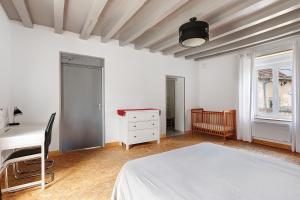 a bedroom with a bed and a desk and a table at Le Gîte des Anges - 12pers, Piscine in Angé +24 photos