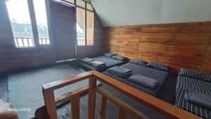 an attic room with three bunk beds in it at Bliss 10 people in Palayangan