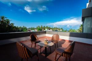 a patio with chairs and a table on a balcony at Grand Continent Hotel, Rameswaram in Rāmeswaram