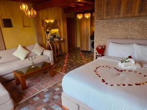 a bedroom with a large bed and a couch at studio Azur rooftop with ocean view terrace privé in Essaouira