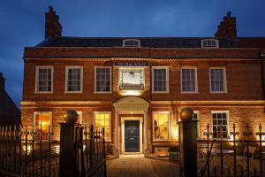 a brick building with a gate in front of it at The Dial House in Reepham