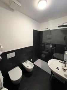 a bathroom with a toilet and a sink and a shower at Hotel Europa in Sondrio +21 photos