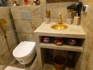 a bathroom with a toilet and a sink and a sink at studio Azur rooftop with ocean view terrace privé in Essaouira