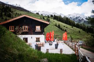 a house with red umbrellas in front of it at Peer Alm in Navis