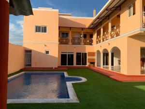 a courtyard of a house with a swimming pool at Villa Patty by the beach in El Conacaste