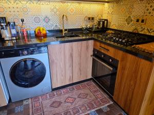 a kitchen with a washing machine and a sink at studio Azur rooftop with ocean view terrace privé in Essaouira +50 photos