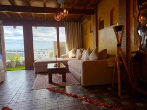 a living room with a couch and a table at studio Azur rooftop with ocean view terrace privé in Essaouira