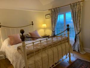 a bedroom with a bed and a window at Foxhill House in Ledbury