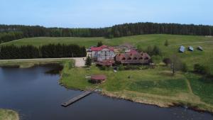 an aerial view of a house on an island in the water at Pensjonat Dolina Wierzby in Olsztyn