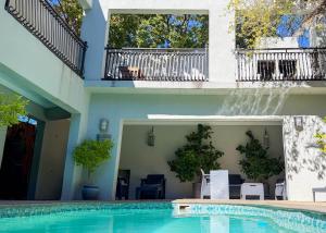 a swimming pool in front of a building at African Sands Guesthouse in Bloemfontein