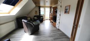 an attic hallway with black chairs and a window at 4 Sterne Ferien Martens in Cuxhaven