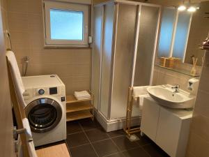 a bathroom with a washing machine and a sink at Lorenzo apartment in Milna