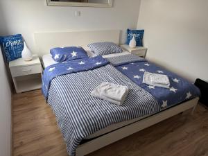 a bedroom with a bed with two towels on it at Lorenzo apartment in Milna