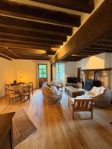 a large living room with a table and chairs at Gîte Les Moreaux in Saint-Amand-en-Puisaye