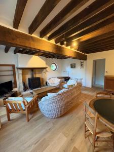 a large living room with a couch and chairs at Gîte Les Moreaux in Saint-Amand-en-Puisaye