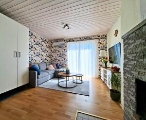 a living room with a couch and a table at Meie Hiiumaa majutus Kärdlas in Kärdla